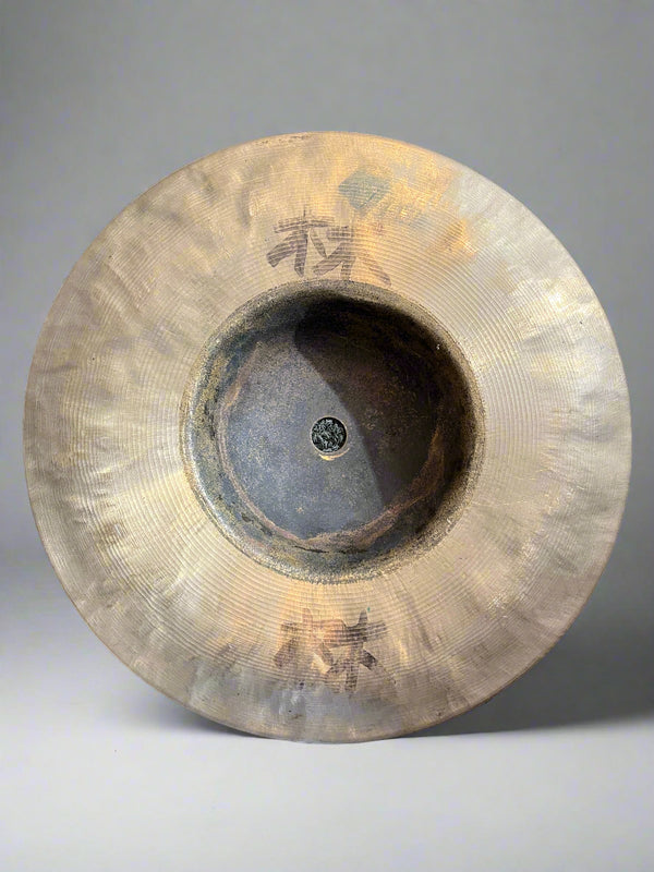 Cymbal on a textured gray surface