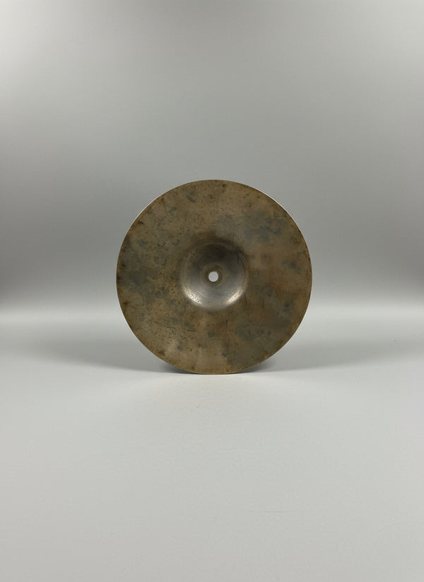 Cymbal on a textured gray surface