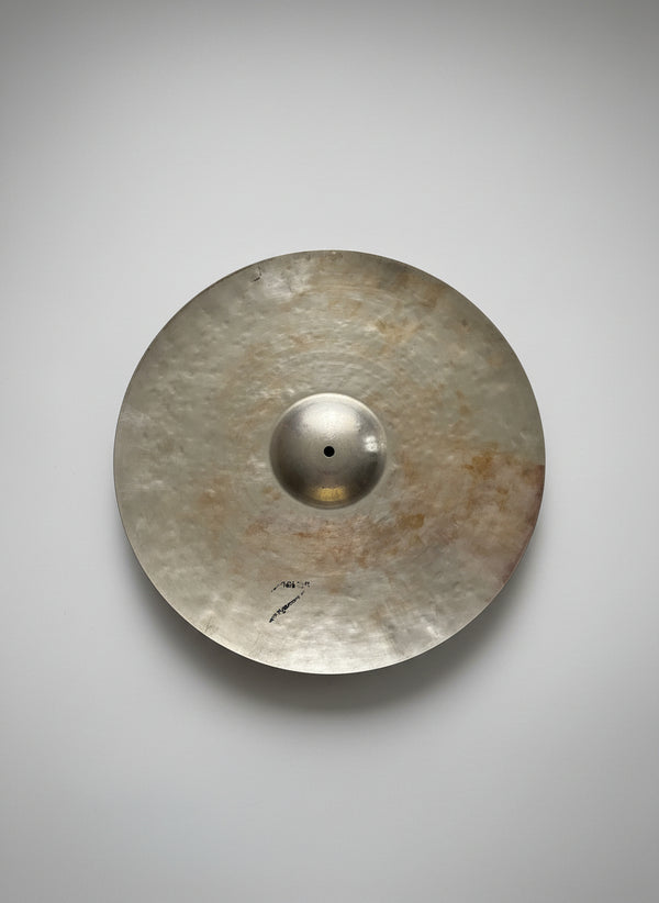 Cymbal on a dark textured surface