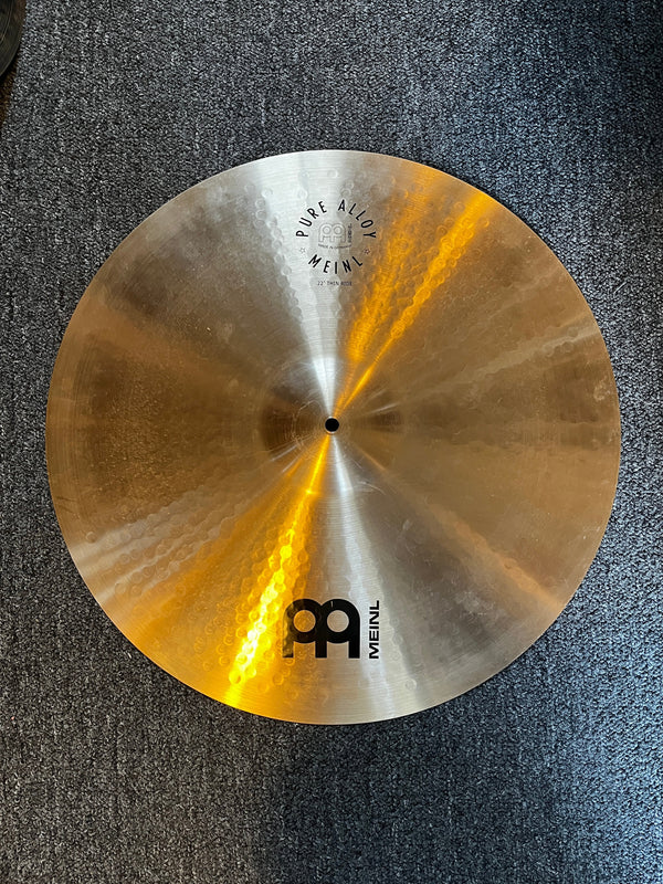 Cymbal with Meinl logo on a textured surface