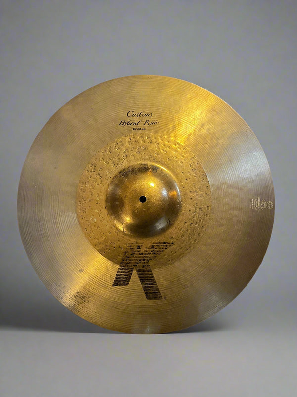 Cymbal with brand logo on a textured surface