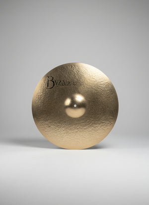 Cymbal with 'Byzance' branding on a dark textured surface