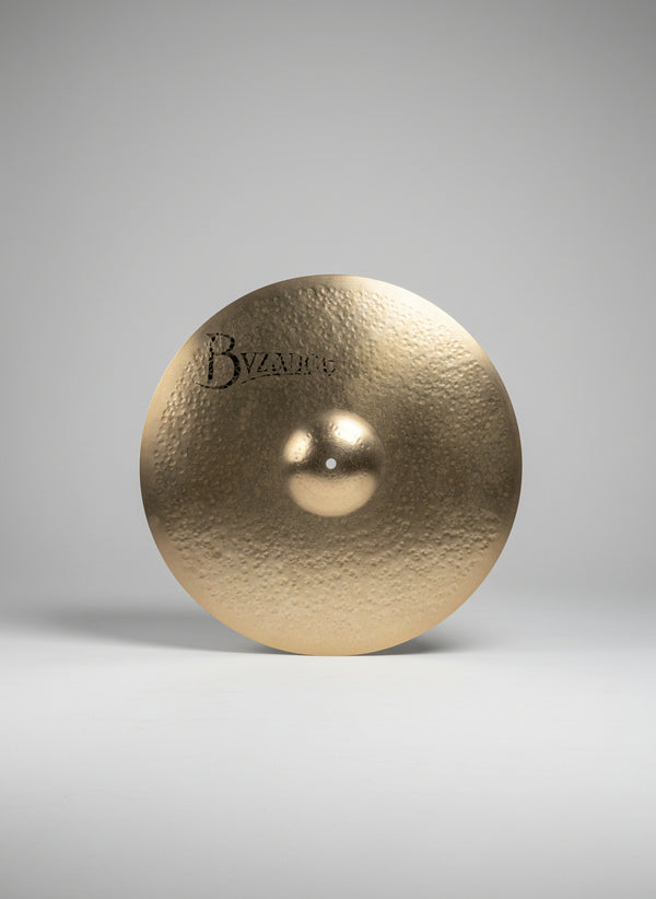 Cymbal with 'Byzance' branding on a dark textured surface