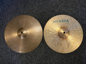 Two Istanbul cymbals on a dark textured surface