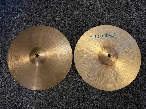 Two Istanbul cymbals on a dark textured surface